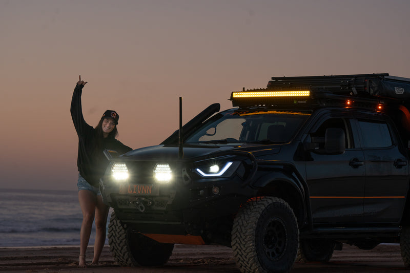 Olivia Keith (LIVNN) beside her 4WD touring rig on the beach